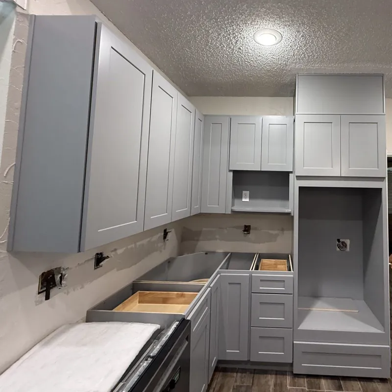 After: the same kitchen with new grey shaker cabinets and oven tower installed by Acue Marmonite, countertops next