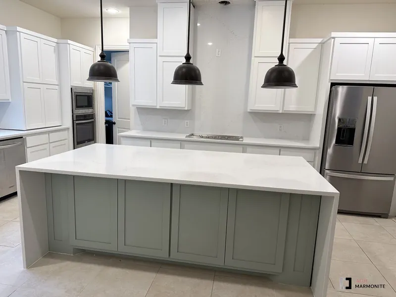 Quartz waterfall island with sage cabinetry