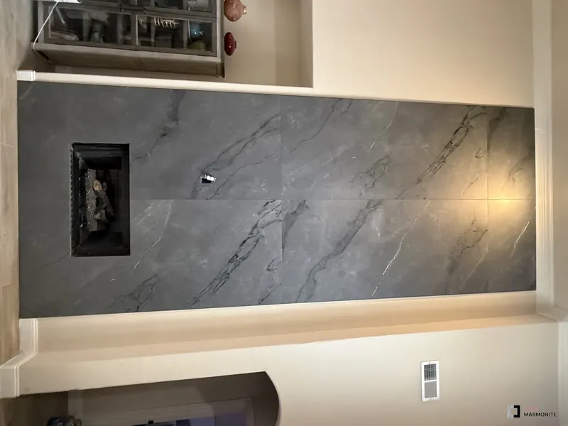 Floor-to-ceiling grey stone fireplace wall