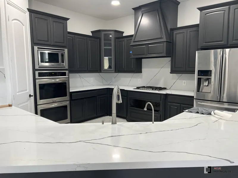 Full kitchen remodel with black cabinetry and marble backsplash