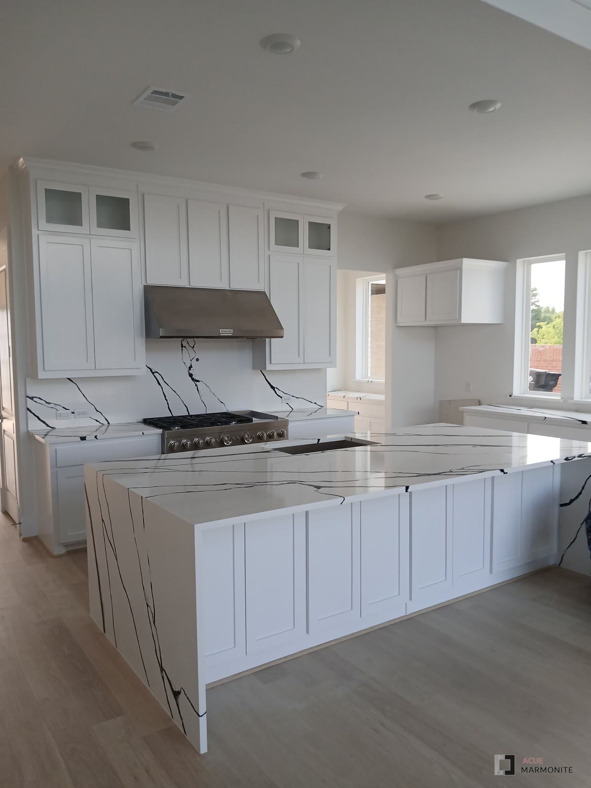 Premade white shaker cabinetry installed by Acue Marmonite