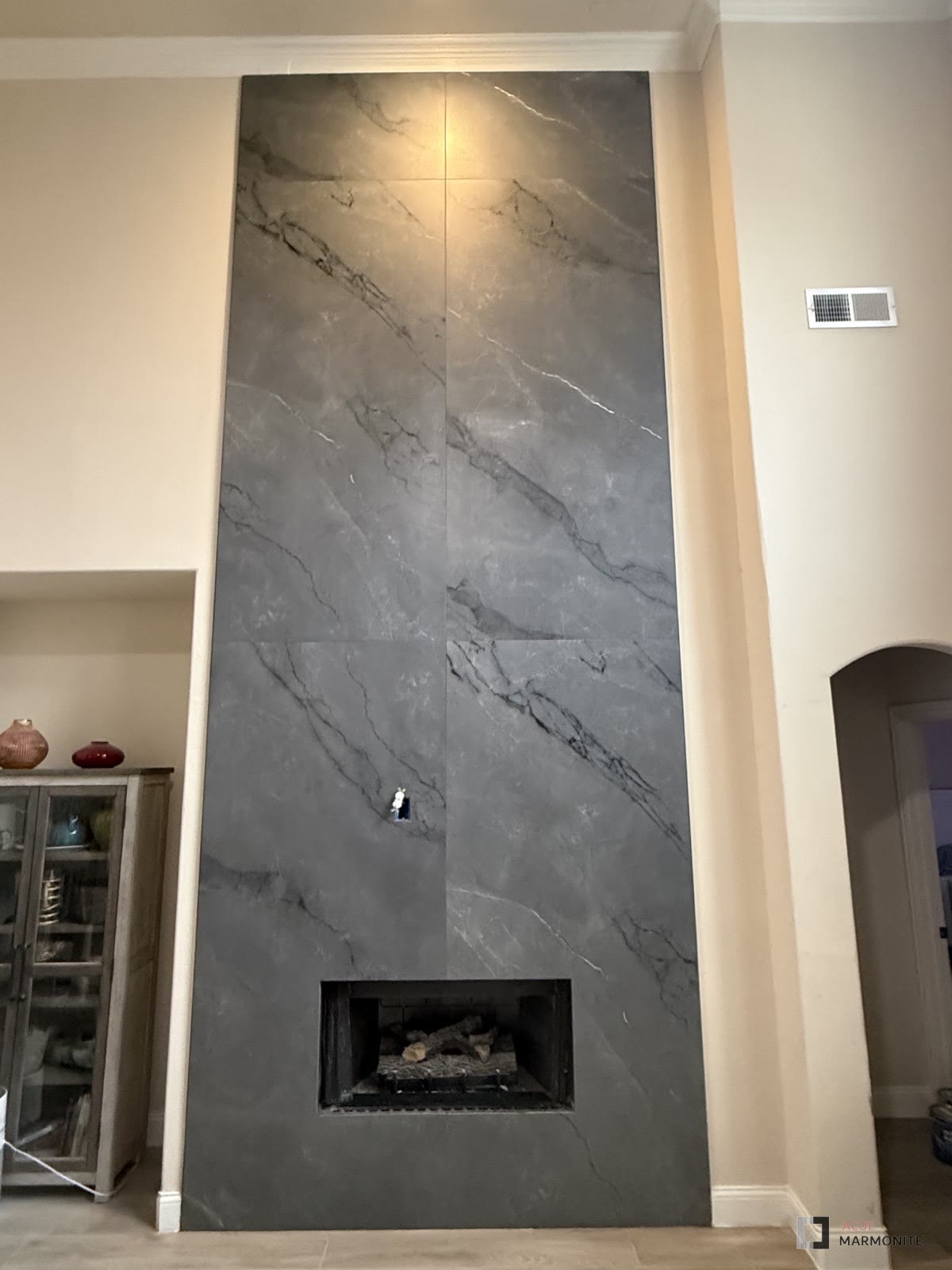 Astonia Grey floor-to-ceiling fireplace wall, installed by Acue Marmonite