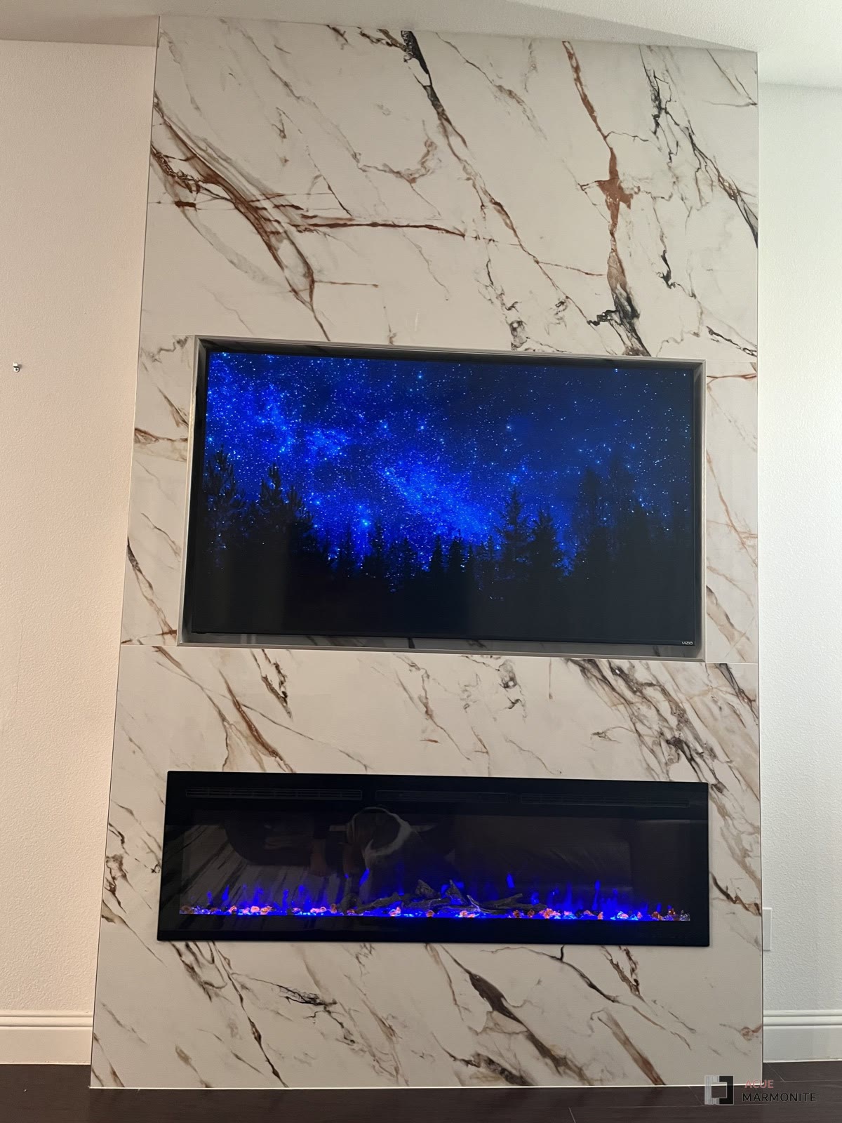 Calacatta Luxe fireplace wall with linear electric insert, installed by Acue Marmonite