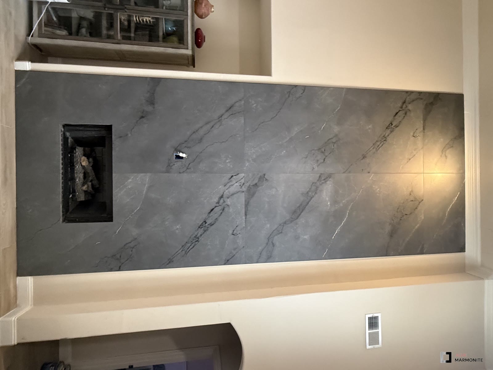Floor-to-ceiling grey stone fireplace wall