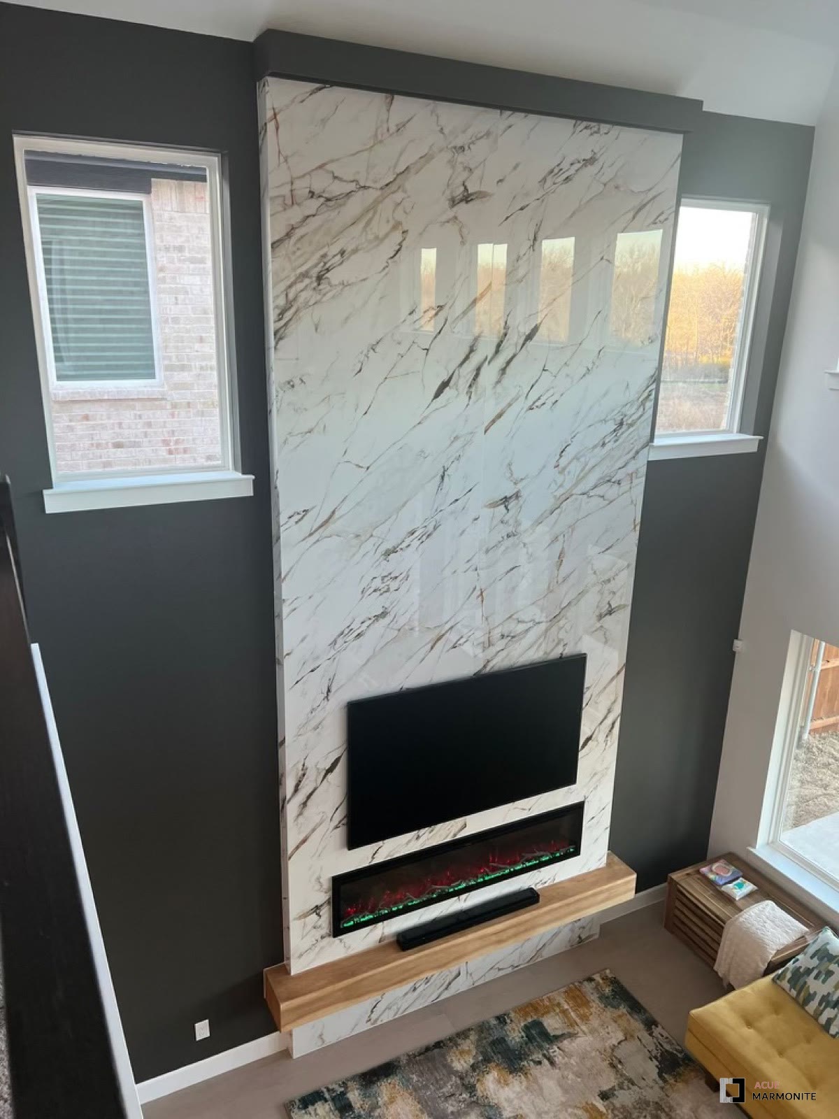 Marble slab fireplace and TV wall with floating mantle