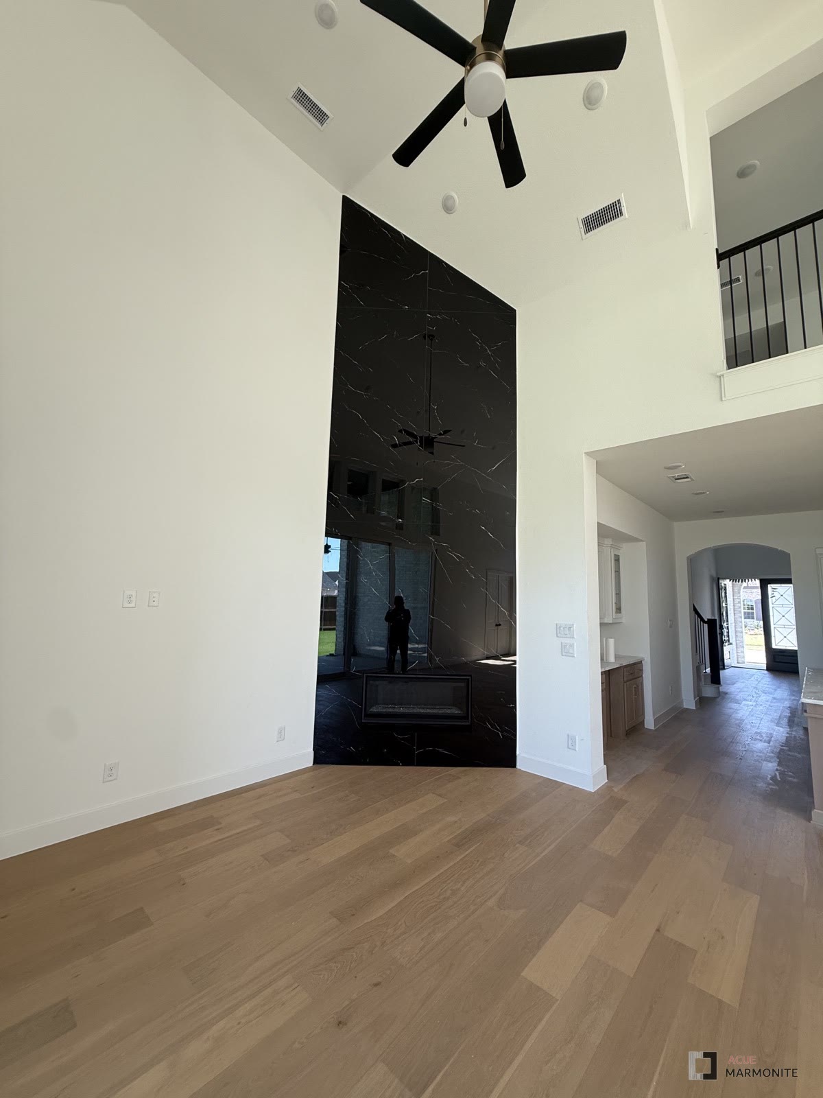 Nero Marquina floor-to-ceiling fireplace wall, installed by Acue Marmonite
