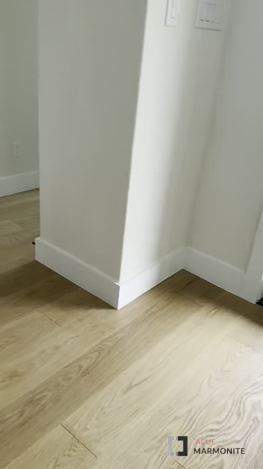 Close-up of engineered wood plank grain and finish, installed by Acue Marmonite
