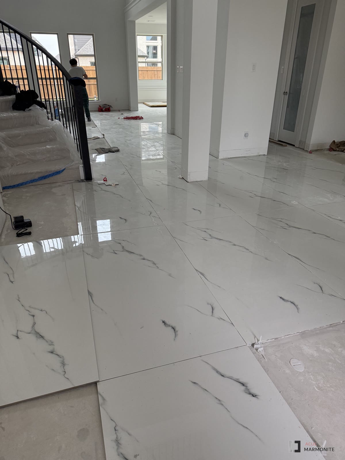 Moon Statuario large-format tile flooring, installed by Acue Marmonite