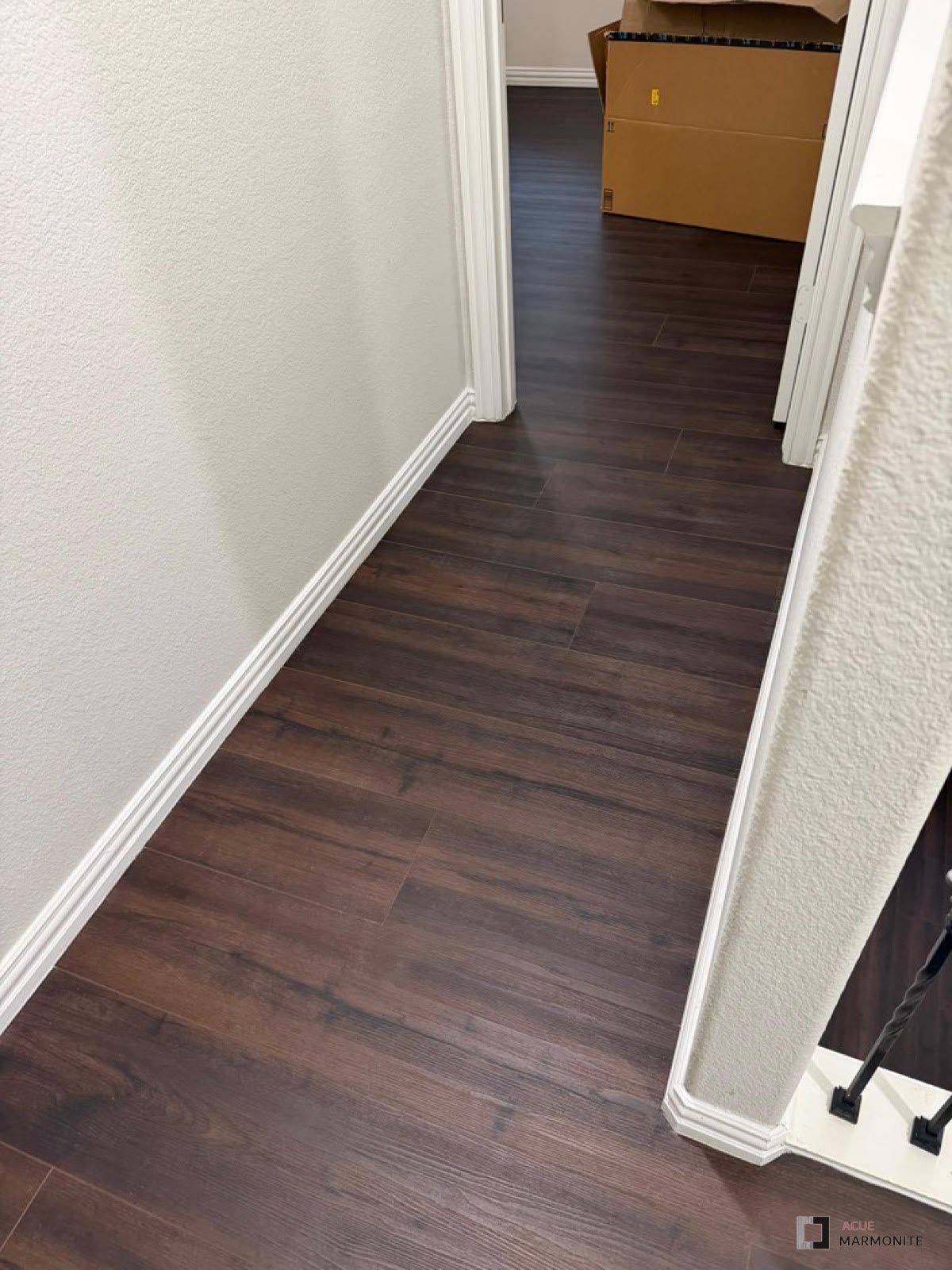 Wood-look vinyl plank flooring in a hallway, installed by Acue Marmonite